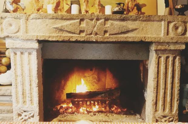 Stone fireplace with prehistoric symbols